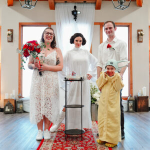 Princess Leia doing a ceremony with happy couple and family.